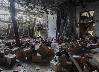 Boxes filled with clothing donations are scattered inside a destroyed cultural centre in Derhachi, eastern Ukraine. A Russian airstrike destroyed the venue on May 12.