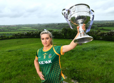 Launching the TG4 All-Ireland championship, Orlagh Lally poses for a portrait with the Brendan Martin cup at the Knowth megalithic passage-tomb site in County Meath.