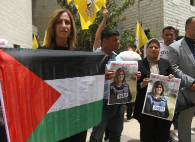 Palestinian students hold pictures of slain Al Jazeera reporter Shireen Abu Aqleh during a protest, at Al-Quds Open University in the city of Nablus in the occupied West Bank.