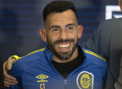 Carlos Tevez smiles wearing the team´s jersey during his presentation.