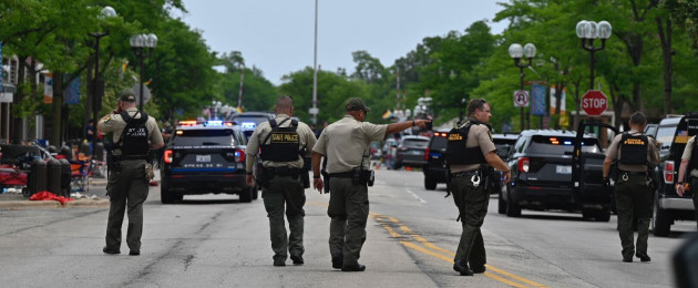 Police searching the downtown area of the Chicago suburb of Highland Park.