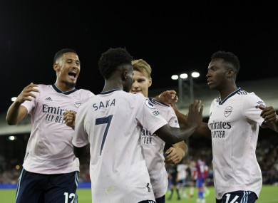 Arsenal players celebrate after Crystal Palace's Marc Guehi scores an own goal.