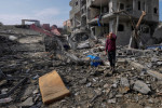 Palestinian inspect the rubble of a building of the Al Nawasrah family destroyed in an Israeli strike in Maghazi refugee camp yesterday.