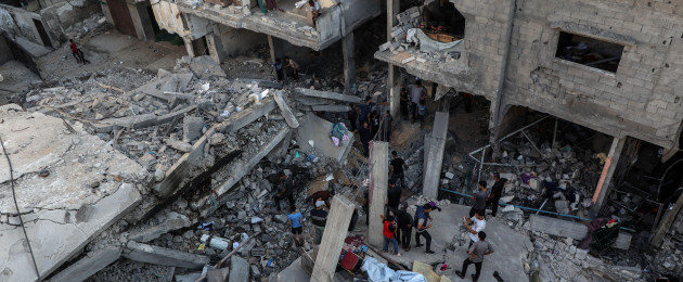Palestinians today at the site of an Israeli airstrike on the al-Shati refugee camp west of Gaza City